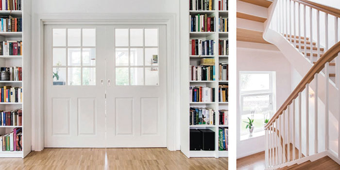Haus-Fleckeby-Innenraum-Ansichten-Bibliothek mit Holzdielenboden und eine weiße gewandelte Treppe ins Obergeschoss